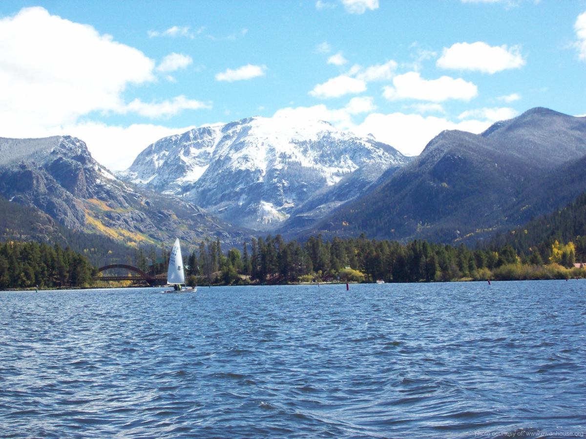 Slide 1 - Picture of Sail boat looking down the channel from Shaddow Mountin Lake to Mt. Craig (Baldy) covered in snow in this fall picture taken in Grand Lake, Colorado